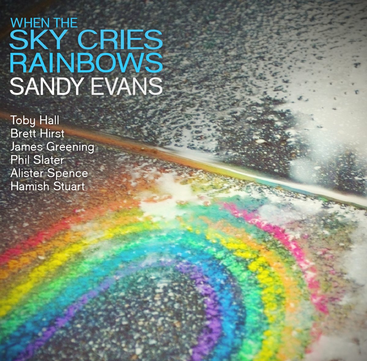 When the Sky Cries Rainbows cover: a rainbow painted on a wet road, the title and musicians at top left